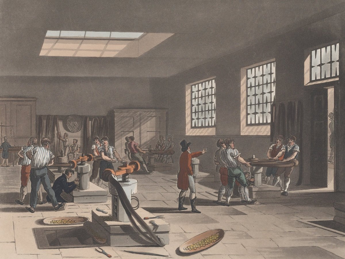 Coloured etching and aquatint: a tall hall with a skylight, in it several screw presses with long swinging arms, with workers standing at them