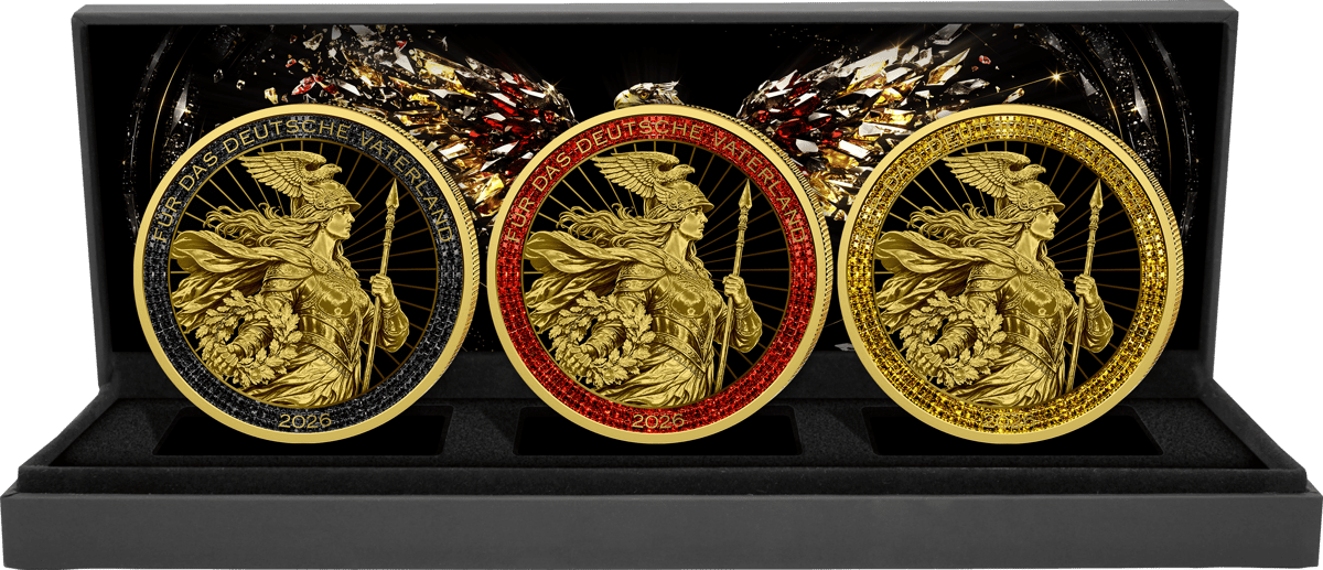 Tres monedas en negro, rojo y oro delante de un estuche negro abierto, con el lado de Germania hacia delante