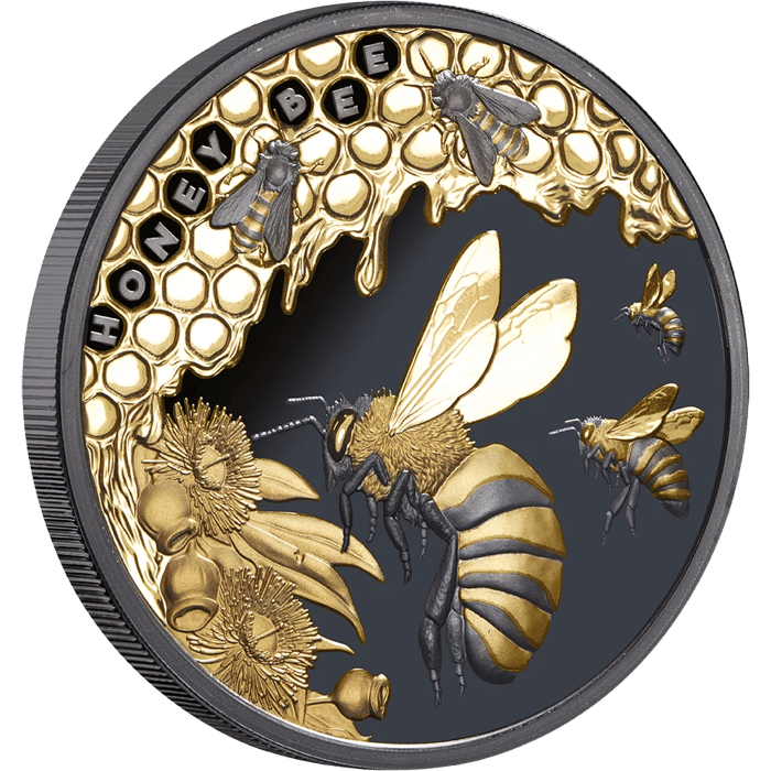 Honey Bee coin in silver, picture side: bees on a comb, set off in a golden tone on a dark background