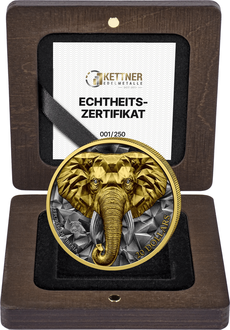 Open wooden case. In the lid a card with the logo KETTNER EDELMETALLE, since 2011, the heading ECHTHEITS‑ZERTIFIKAT and the number 001/250; in front of it stands the part‑gilded elephant with REPUBLIC OF LIBERIA and 20 DOLLARS.